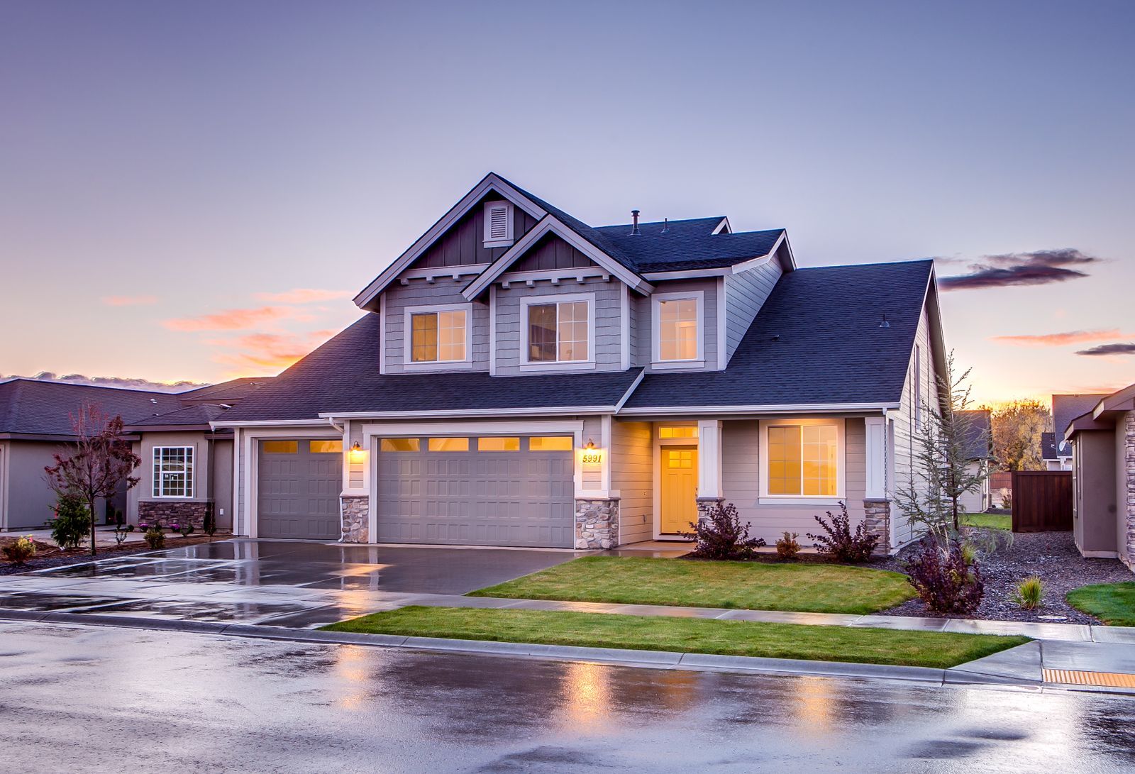 House with a concrete driveway at dusk (stock photo)